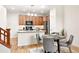 A cozy kitchen with wood cabinets, stainless steel appliances, granite countertops and a dining table is perfect for entertaining at 5836 S Vivian Way, Littleton, CO 80127