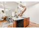 Open concept kitchen with stainless appliances and a dining area with great natural light leads to a Gathering room at 5836 S Vivian Way, Littleton, CO 80127