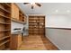 Bright office featuring custom wooden built-in shelves, work space, light hardwood floors, and modern lighting at 5836 S Vivian Way, Littleton, CO 80127