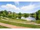 Scenic view of pond with landscaped amphitheater and neighborhood houses at 5836 S Vivian Way, Littleton, CO 80127