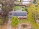 An aerial view of the home showcases the backyard, solar panels, landscaping, and mature trees surrounding the property at 3379 W Wagon Trail Dr, Englewood, CO 80110
