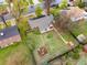 Aerial view of a home's backyard featuring a fire pit, lush lawn, mature trees, and a storage shed at 3379 W Wagon Trail Dr, Englewood, CO 80110