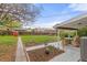 Large backyard featuring a covered patio, garden, and lush lawn at 3379 W Wagon Trail Dr, Englewood, CO 80110