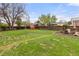 Expansive backyard with a lush lawn, wooden fence, and shed at 3379 W Wagon Trail Dr, Englewood, CO 80110