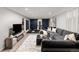 Finished basement with large seating area, exercise equipment, and modern finishes at 3379 W Wagon Trail Dr, Englewood, CO 80110