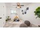 bedroom with play tent, neutral colors, lots of light, and playful dinosaur decor at 3379 W Wagon Trail Dr, Englewood, CO 80110