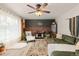 Inviting living room features a large window, stylish decor, a ceiling fan, and comfortable seating at 3379 W Wagon Trail Dr, Englewood, CO 80110