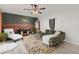 Bright living room offers a unique brick accent wall, modern decor, comfortable seating, and plenty of natural light at 3379 W Wagon Trail Dr, Englewood, CO 80110