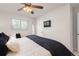Bright bedroom with ceiling fan, large window, and stylish decor at 3379 W Wagon Trail Dr, Englewood, CO 80110