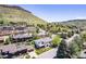 Aerial view of a beautiful neighborhood with tree-lined streets and picturesque mountains at 330 Ptarmigan St, Golden, CO 80403