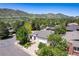 Aerial view of a charming neighborhood with tree-lined streets and mountain views at 330 Ptarmigan St, Golden, CO 80403