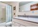 Bathroom featuring modern sink and vanity, mirror, with shower and tub combination behind a shower curtain at 330 Ptarmigan St, Golden, CO 80403