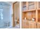 Well-lit bathroom with glass shower, toilet, and built in storage with glass doors at 330 Ptarmigan St, Golden, CO 80403
