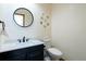 Powder bathroom featuring a new vanity with a modern black faucet, and a round decorative mirror at 330 Ptarmigan St, Golden, CO 80403