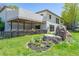 Modern home featuring an outdoor deck, lush landscaping and boulder accents at 330 Ptarmigan St, Golden, CO 80403