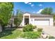 Attractive single-story home featuring a well-manicured front yard, mature trees, and an attached two-car garage at 330 Ptarmigan St, Golden, CO 80403