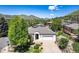 Charming single-story home with mature trees, lush landscaping, and an attached two-car garage at 330 Ptarmigan St, Golden, CO 80403