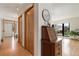 Light-filled hallway featuring hardwood floors and closet space and a nook with an antique desk at 330 Ptarmigan St, Golden, CO 80403
