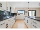 Bright kitchen featuring white cabinetry, dark countertops, and a window offering lovely views at 330 Ptarmigan St, Golden, CO 80403