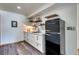 A modern kitchenette with a black retro-style refrigerator, a stainless steel sink and floating shelves at 330 Ptarmigan St, Golden, CO 80403