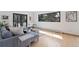 Bright living room with hardwood floors, modern furniture, and a large window offering natural light at 330 Ptarmigan St, Golden, CO 80403