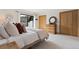 Bedroom with natural wood furniture, light colored carpet and decor, and sliders to the deck at 330 Ptarmigan St, Golden, CO 80403