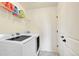 Laundry room with washer, dryer, and ample shelving at 9091 E 59Th North Pl, Denver, CO 80238