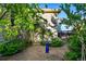 Secluded backyard with gravel, landscaping, and birdbath at 3240 Spruce St, Denver, CO 80238