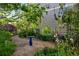 Backyard garden featuring a gravel path, birdbath, and vibrant flowerbeds at 3240 Spruce St, Denver, CO 80238