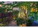 Beautiful backyard garden with decorative lights strung in the trees and a gravel pathway at 3240 Spruce St, Denver, CO 80238