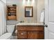 Charming bathroom featuring wood accents, granite countertops, and a vintage-style storage shelf at 3240 Spruce St, Denver, CO 80238
