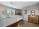 Cozy bedroom with ample natural light, vintage dresser, and classic four-poster bed at 3240 Spruce St, Denver, CO 80238