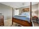 Comfortable bedroom with soft carpet, a four-poster bed, and a side table with reading lamp at 3240 Spruce St, Denver, CO 80238