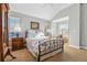 Inviting bedroom with vaulted ceiling, bright windows, and charming decor at 3240 Spruce St, Denver, CO 80238