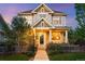 Charming two-story home boasts a welcoming front porch and manicured front yard at 3240 Spruce St, Denver, CO 80238