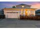 Charming two-story home with a covered porch, two car garage and inviting curb appeal at sunset at 3240 Spruce St, Denver, CO 80238