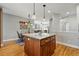 Open kitchen featuring a granite island, pendant lighting, and seamless connection to dining area at 3240 Spruce St, Denver, CO 80238