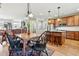Open concept kitchen and dining area features stainless steel appliances and wood cabinetry at 3240 Spruce St, Denver, CO 80238
