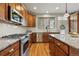 Bright kitchen with granite countertops, stainless steel appliances, and ample wooden cabinet space at 3240 Spruce St, Denver, CO 80238
