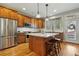 Well-equipped kitchen boasts stainless steel appliances, a granite island, and wooden cabinetry at 3240 Spruce St, Denver, CO 80238