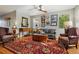 Cozy living room with hardwood floors, a ceiling fan, and plentiful natural light at 3240 Spruce St, Denver, CO 80238