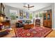 Well-lit living room features hardwood floors, a comfortable sofa, and abundant artwork at 3240 Spruce St, Denver, CO 80238