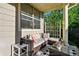 Relaxing porch with wicker seating, decorative pillows, and a charming glass coffee table at 3240 Spruce St, Denver, CO 80238