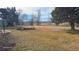 Expansive backyard featuring mature trees, a trampoline, and swings, offering ample space for recreation at 15600 E 33Rd Pl, Aurora, CO 80011