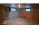 Unfinished basement with concrete walls, wood paneling and two windows awaiting your renovation ideas at 15600 E 33Rd Pl, Aurora, CO 80011