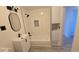 Chic bathroom boasts modern fixtures, a tiled shower-tub, and ample storage space in a white vanity at 15600 E 33Rd Pl, Aurora, CO 80011
