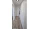 Hallway featuring modern flooring, neutral wall colors, and a view into other rooms at 15600 E 33Rd Pl, Aurora, CO 80011