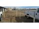 Horse pen area with trucks and equipment, providing an overview of the facilities at 15600 E 33Rd Pl, Aurora, CO 80011