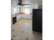 Functional kitchen showcasing white cabinetry, contrasting appliances, and tile flooring at 15600 E 33Rd Pl, Aurora, CO 80011