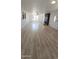 Spacious living room showcasing wood-style flooring, stone fireplace, and ample natural light at 15600 E 33Rd Pl, Aurora, CO 80011